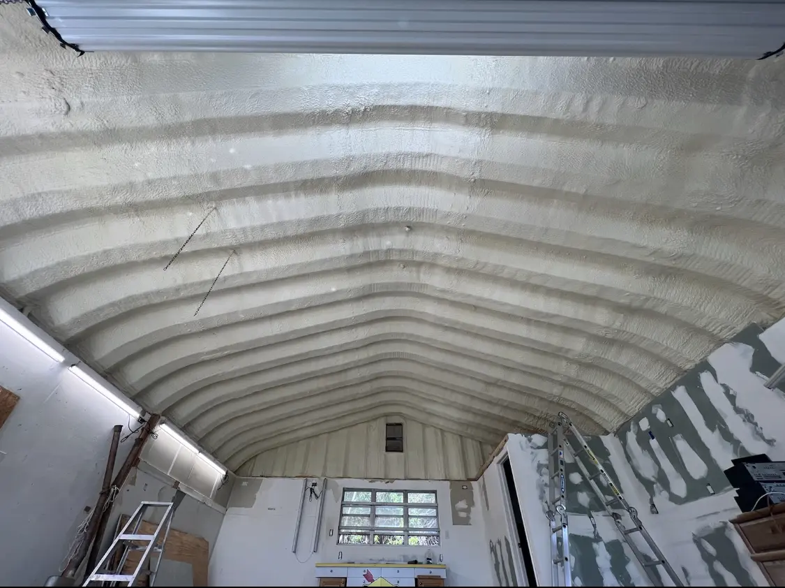 Spray polyurethane foam applied to the underside of a metal roof deck in Arab